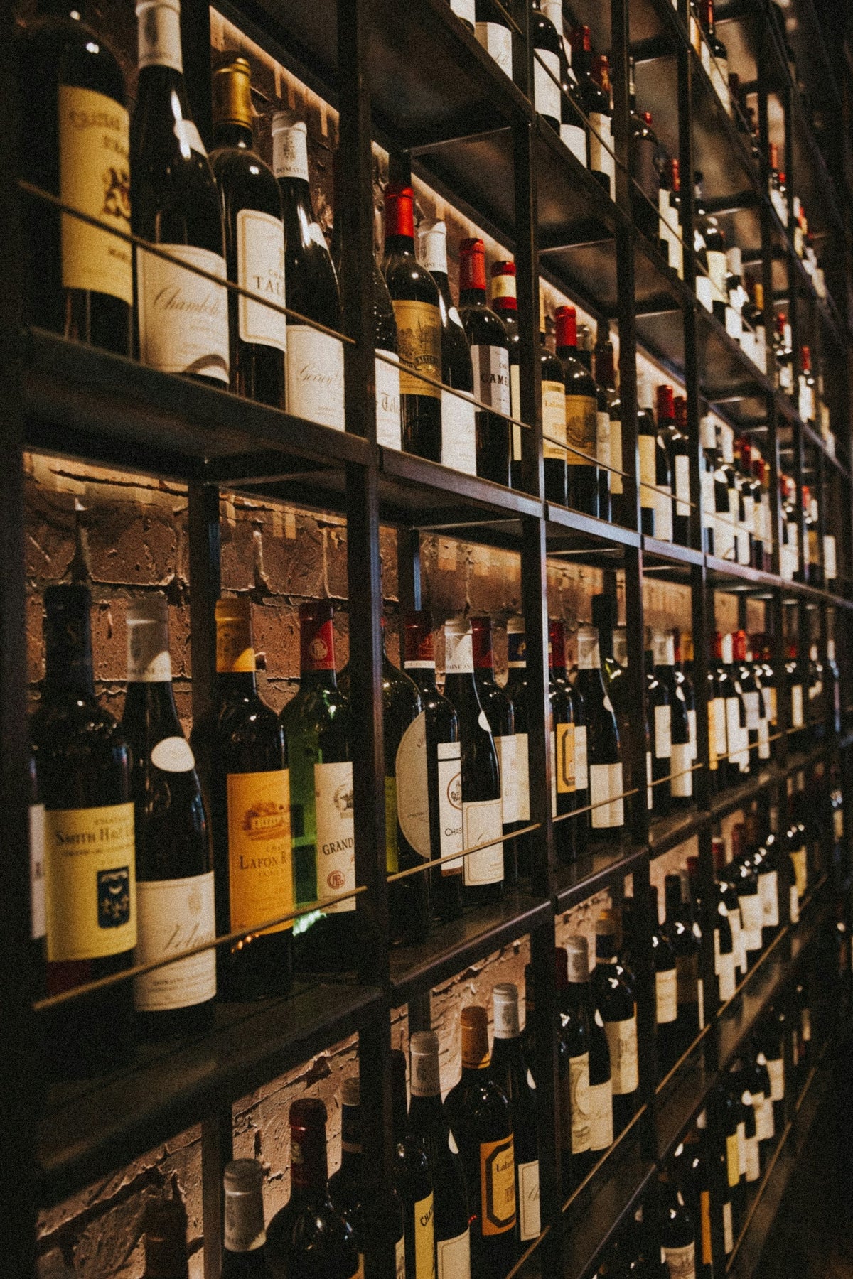 Rows of wine bottles on a wine shop rack