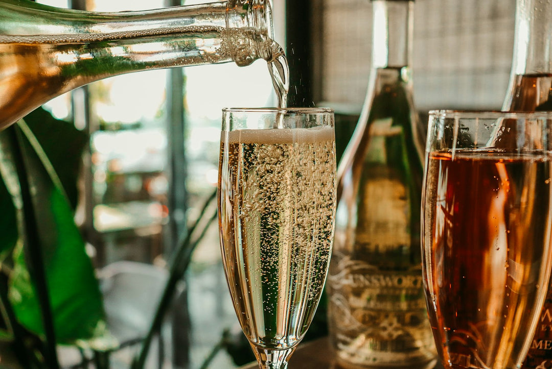 Sparkling wine being poured into glasses outdoors