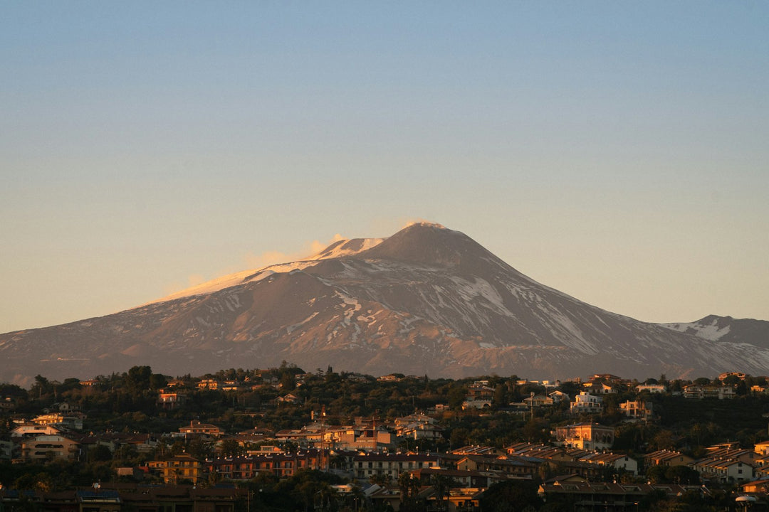 Snow-capped Mount Etna at sunset above Catania, Sicily