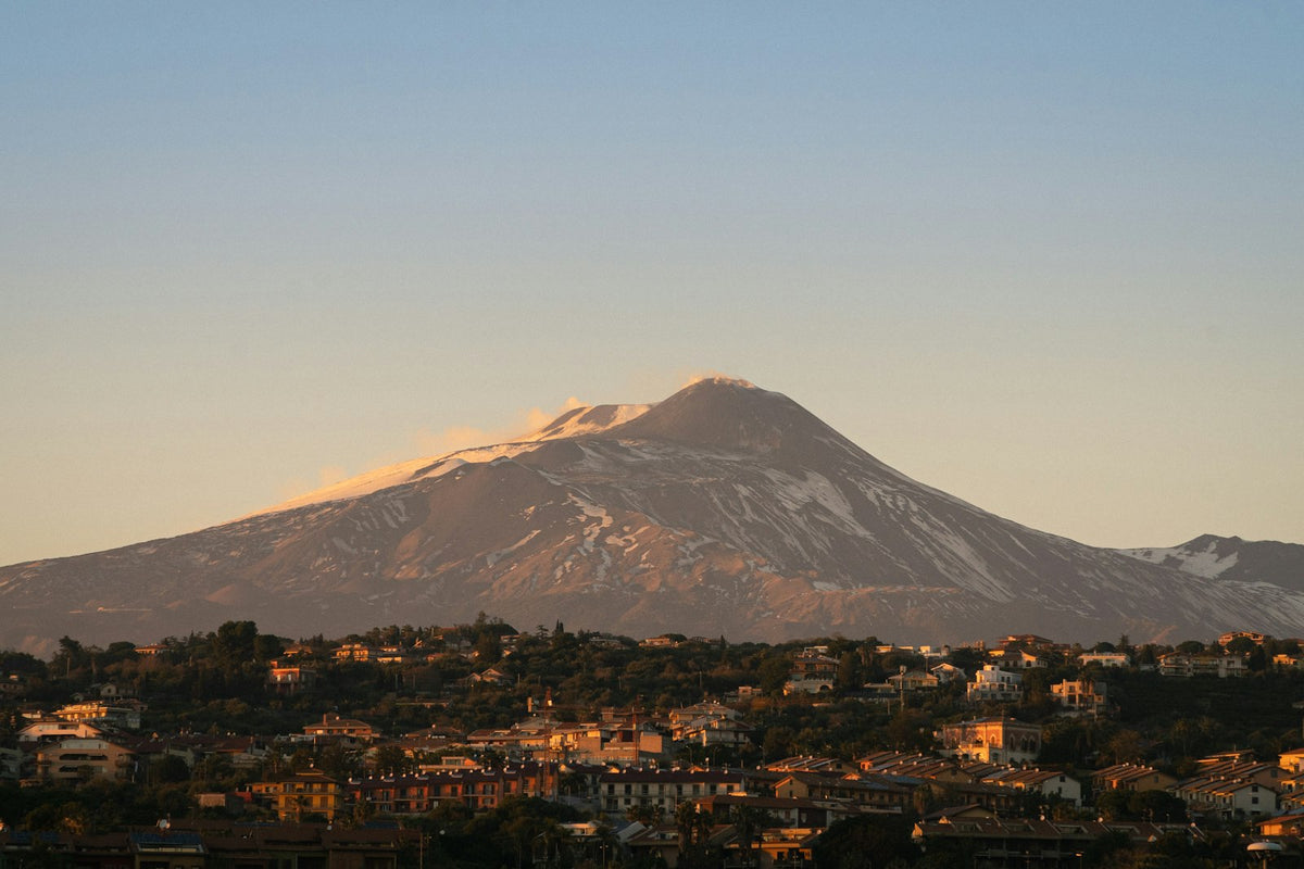Snow-capped Mount Etna at sunset above Catania, Sicily