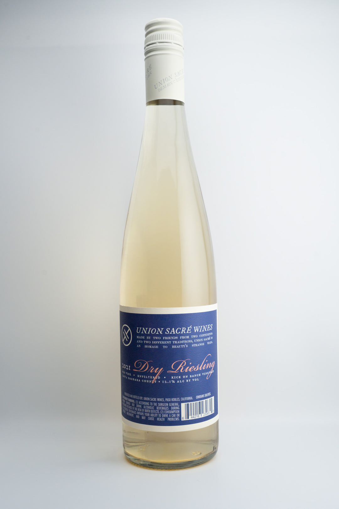 A bottle of 2021 Union Sacré Dry Riesling wine with a white label and blue text, indicating the brand and variety.