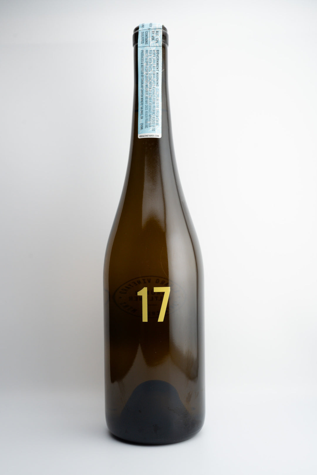 A bottle of 2017 Vöcal Vineyards Gruner Veltliner wine with a label indicating the vintage and brand.
