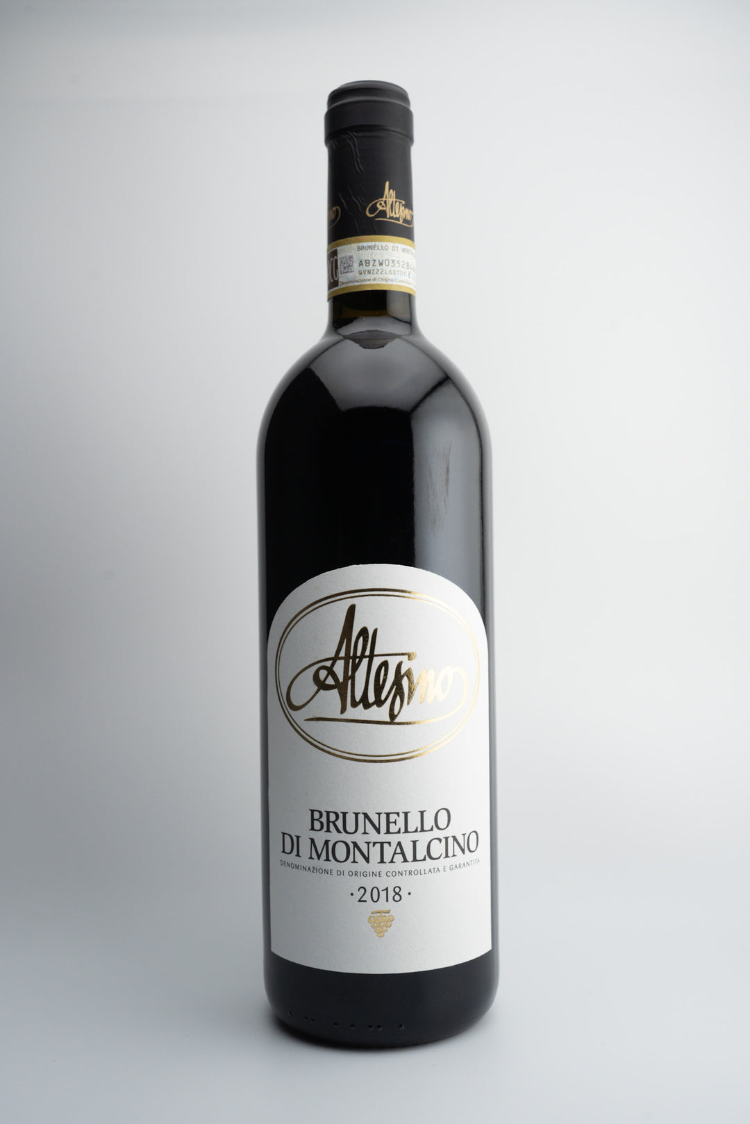 A bottle of 2018 Altesino Brunello di Montalcino wine with a label showing the brand name and the vintage year.