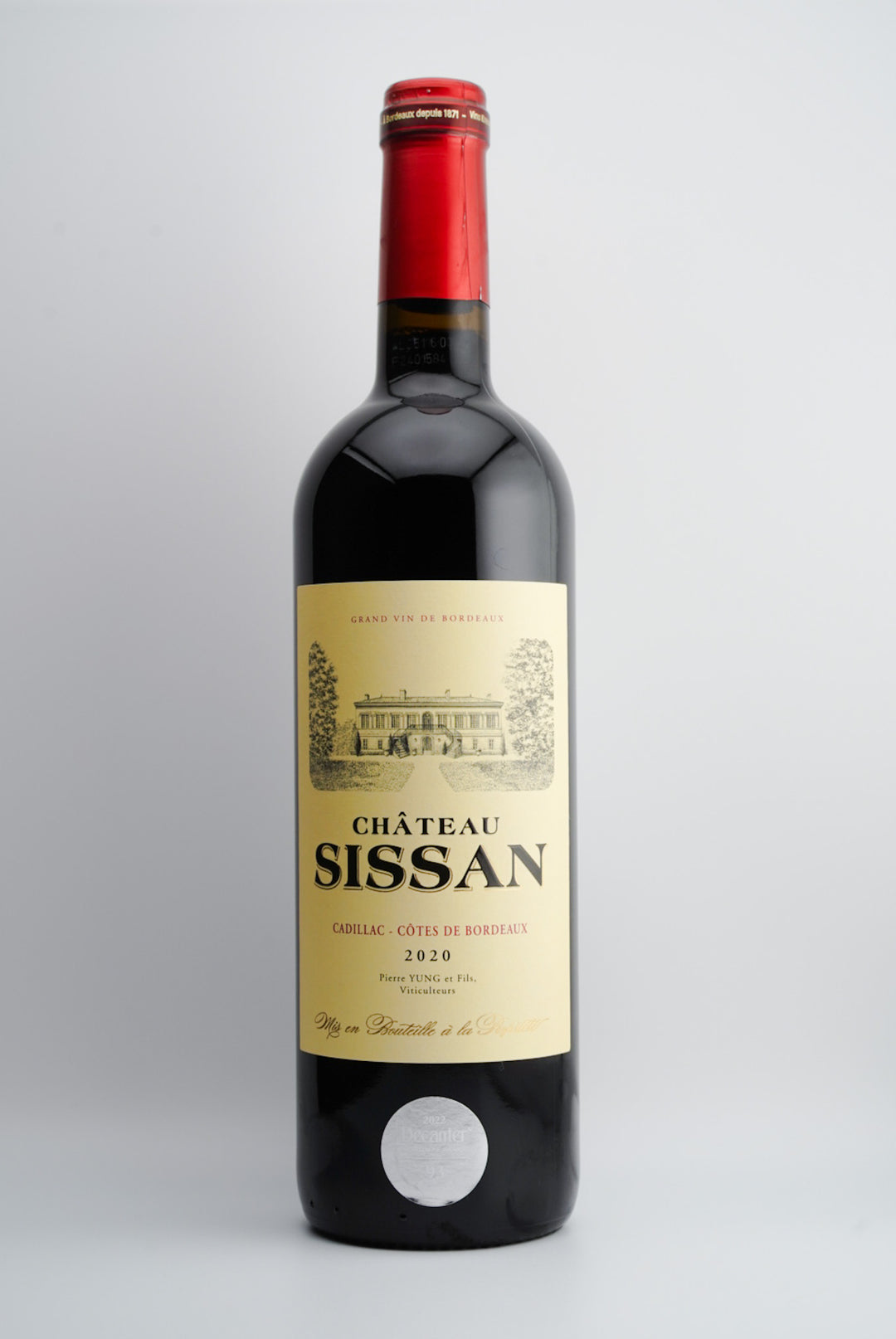 A bottle of 2020 Chéteau Sissan Cadillac-Côtes de Bordeaux wine with a red cap and a label featuring the chéteau's name and the appellation of the wine.