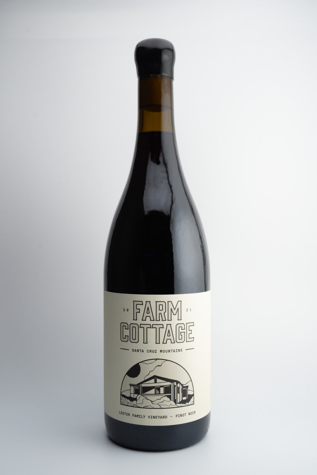 A bottle of 2021 Farm Cottage Wines Pinot Noir with a label showcasing the winery's name and the Santa Cruz Mountains region.