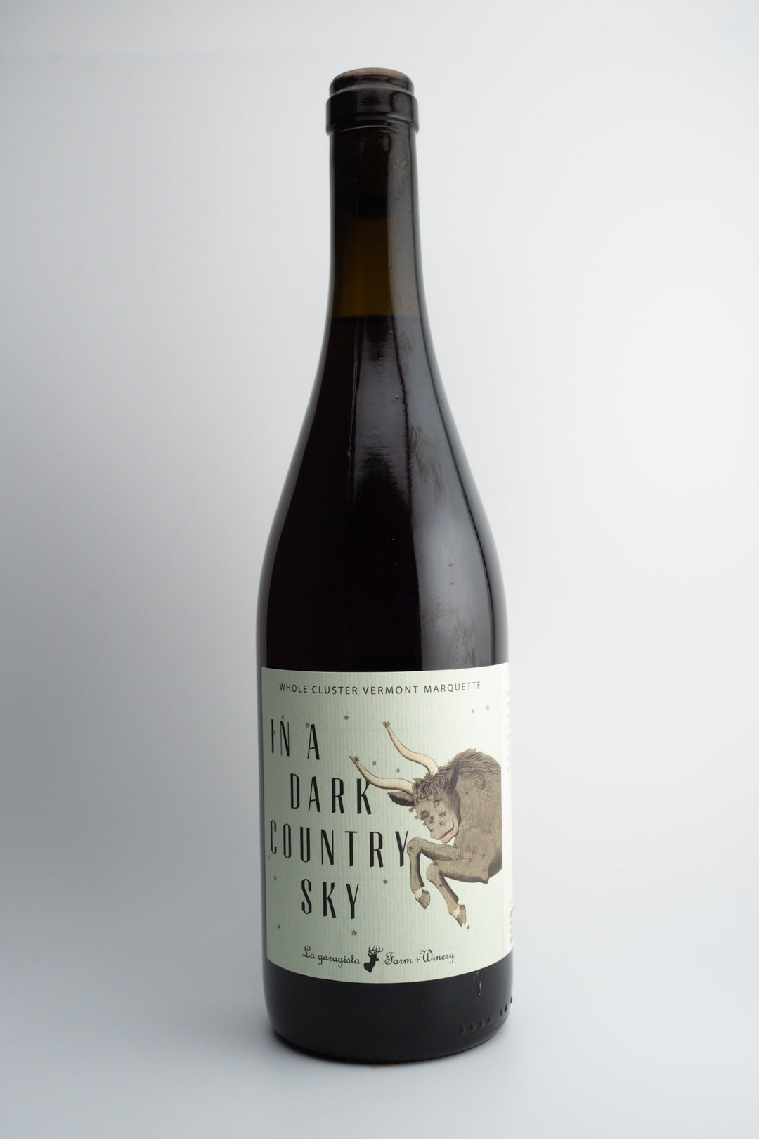 A bottle of 2021 La Garagista 'In a Dark Country Sky' wine with a label featuring an illustration of a bull.