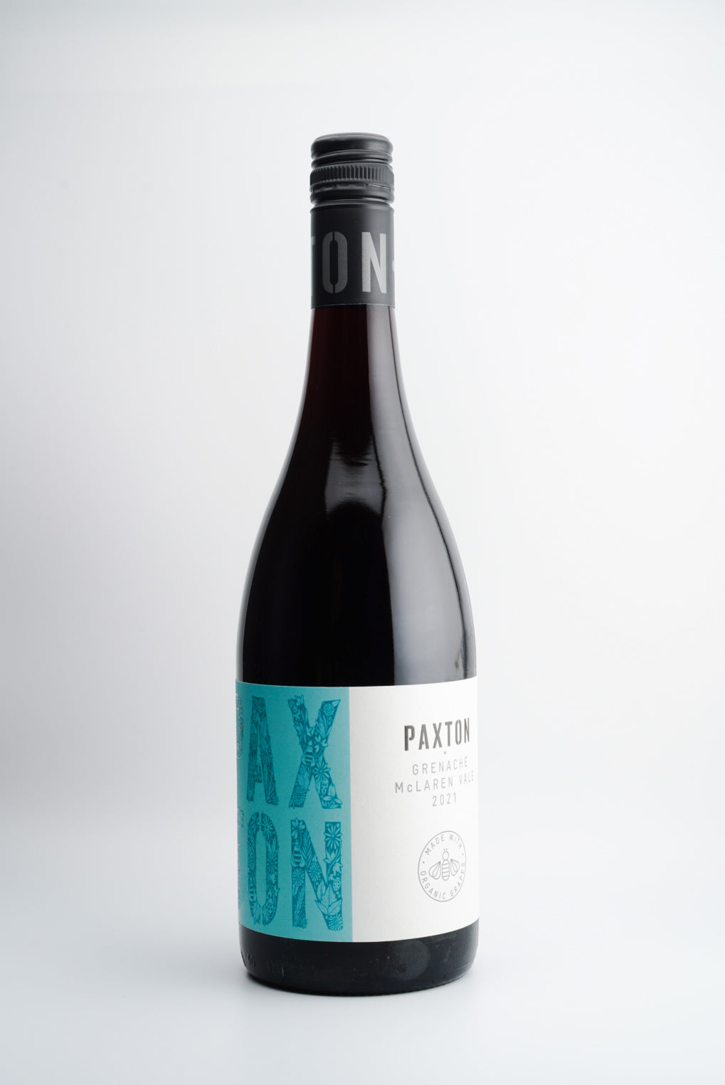 A bottle of 2021 Paxton Grenache wine with a teal label, from McLaren Vale, South Australia.