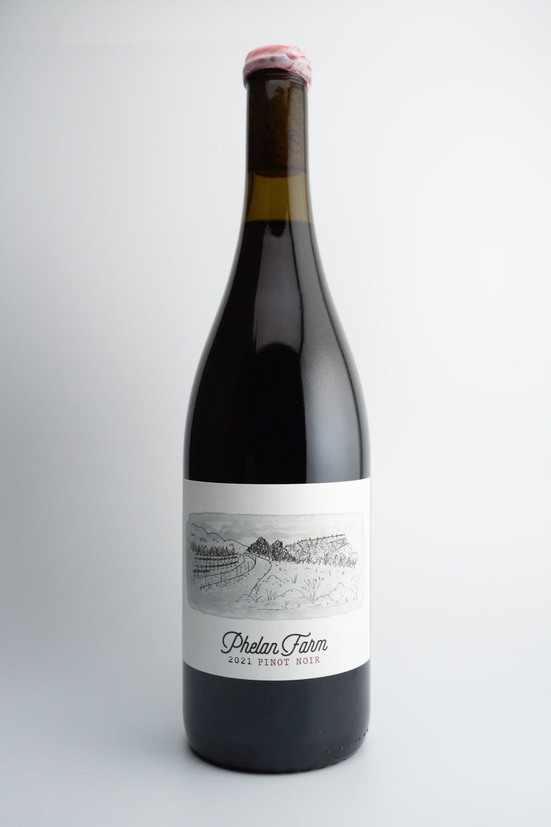 A bottle of 2021 Phelan Farms Pinot Noir with a label that includes the wine variety and the San Luis Obispo Coast location. The cap of the bottle is red.