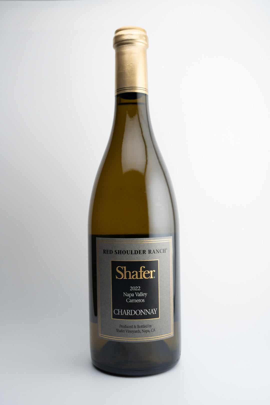 A bottle of 2021 Shafer Vineyards Chardonnay wine from Red Shoulder Ranch, Napa Valley, with a white label and gold text.