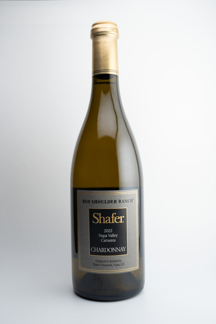 A bottle of 2021 Shafer Vineyards Chardonnay wine from Red Shoulder Ranch, Napa Valley, with a white label and gold text.