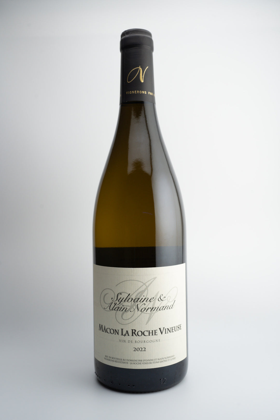 A bottle of 2022 Sylvaine et Alaine Normand La Roche-Vineuse white wine, with a label primarily in white and gray tones, and the text 'MACON AOC, BURGUNDY, FRANCE'.
