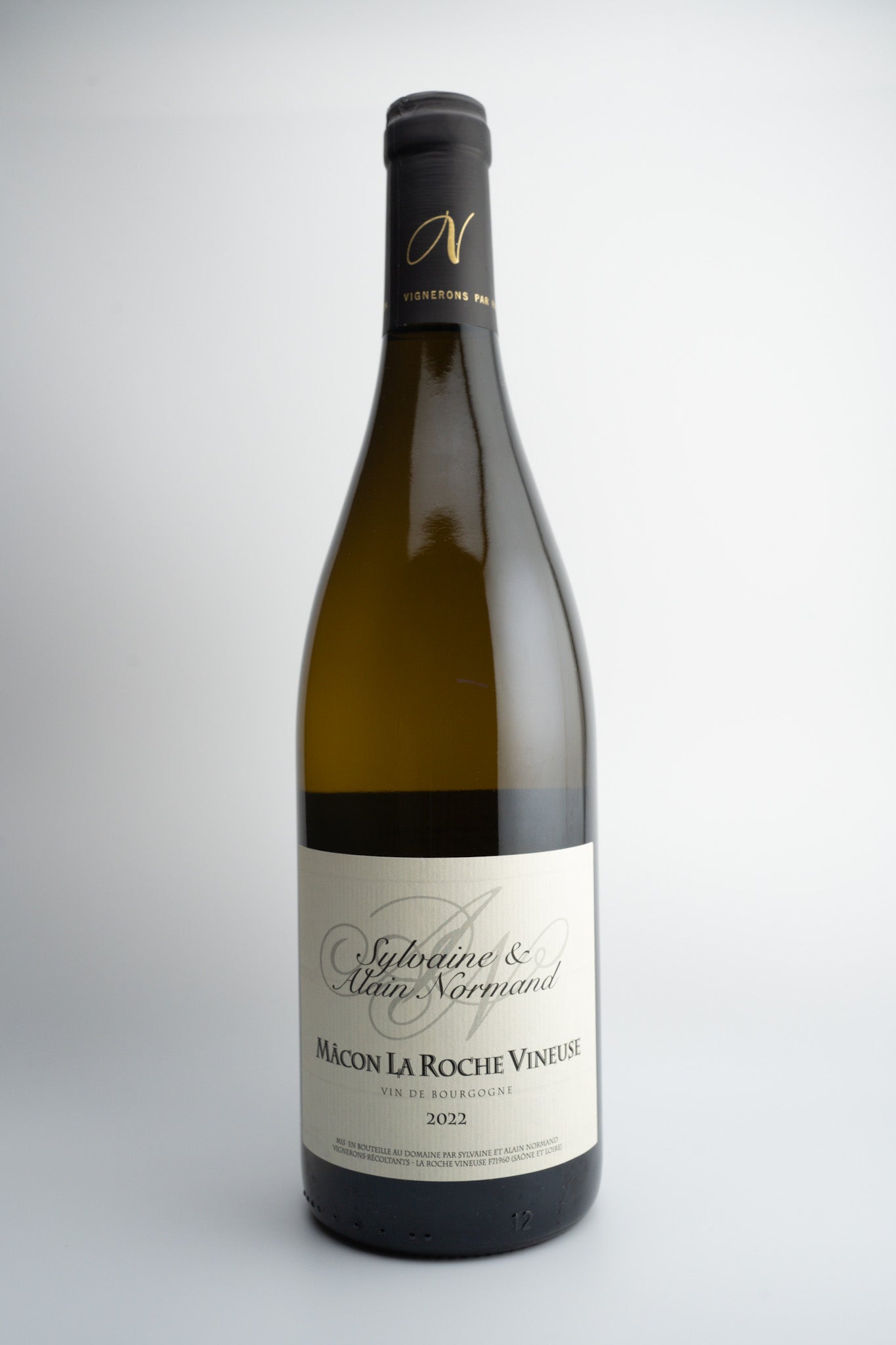 A bottle of 2022 Sylvaine et Alaine Normand La Roche-Vineuse white wine, with a label primarily in white and gray tones, and the text 'MACON AOC, BURGUNDY, FRANCE'.