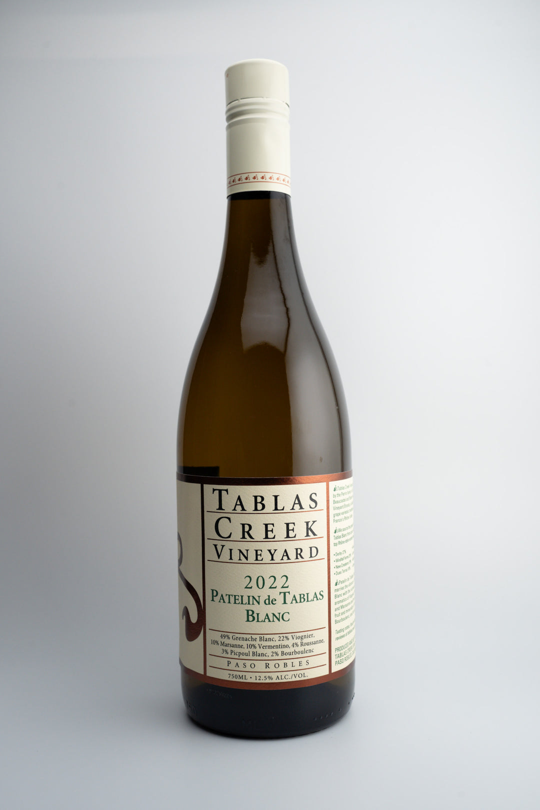 A bottle of 2022 Tablas Creek Patelin de Tablas Blanc wine with a white label, displaying the brand, variety, and vintage information.