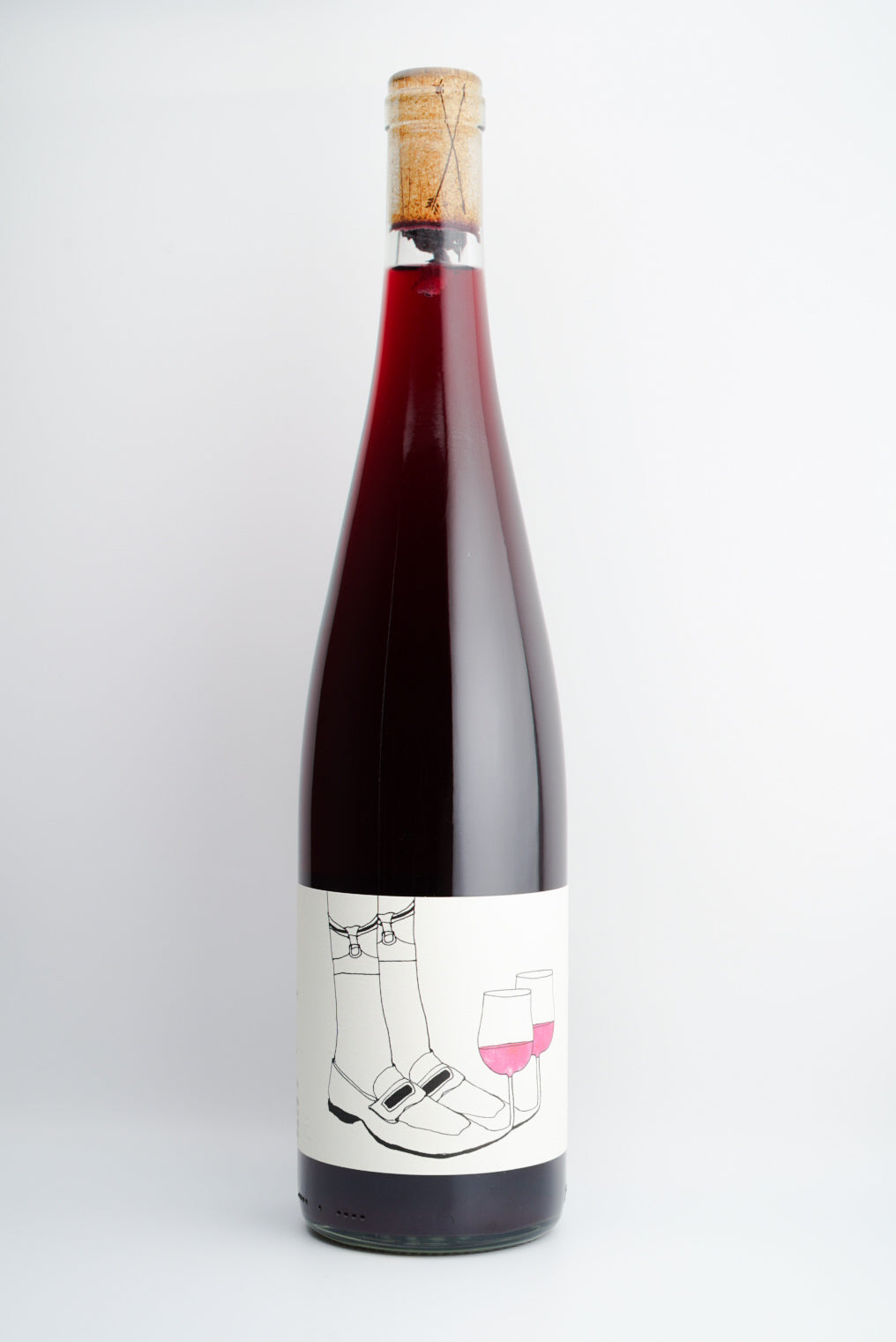 A bottle of 2023 Las Jaras 'Slipper Sipper' Nouveau wine with a label featuring a drawing of a slipper and a wine glass.