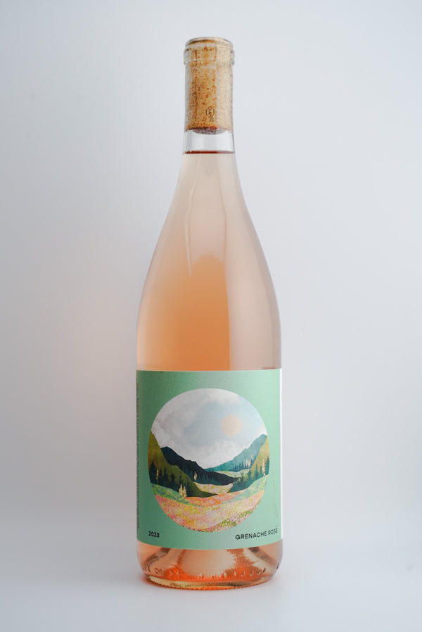 A bottle of 2023 Outward Wines Two Wolves Vineyard Rosé of Grenache with a label depicting a landscape,Santa Barbara, California.
