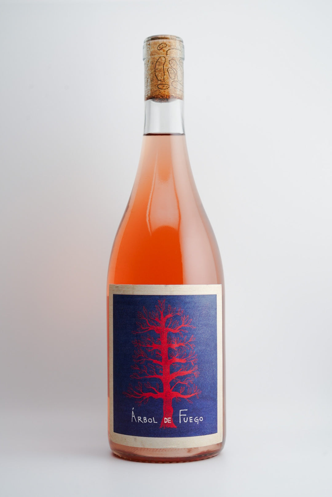A bottle of 2023 Vinos Pijoan 'Arbol de Fuego', Valle de Guadalupe, Mexico wine with a pink label showcasing a tree.