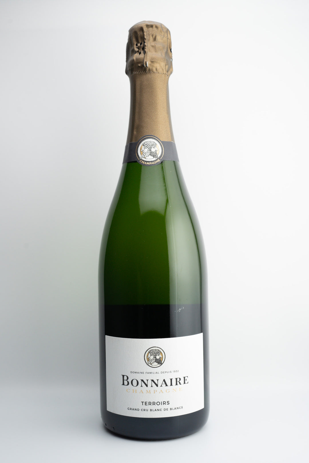 A bottle of Bonnaire house Champagne, with a celebratory cork on top, against a plain background.