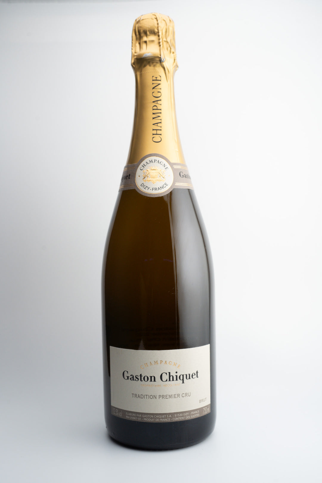 A bottle of Champagne Gaston Chiquet Premier Cru 'Tradition' Brut NV with a golden foil cover on top and a label that includes the brand and vintage information.