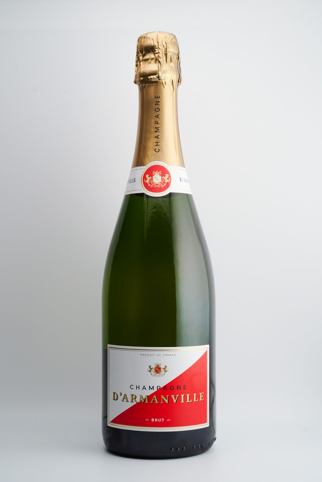 A bottle of D'Armanville Brut Champagne NV with a gold foil top and a label that includes the name of the brand and the word 'Brut'.
