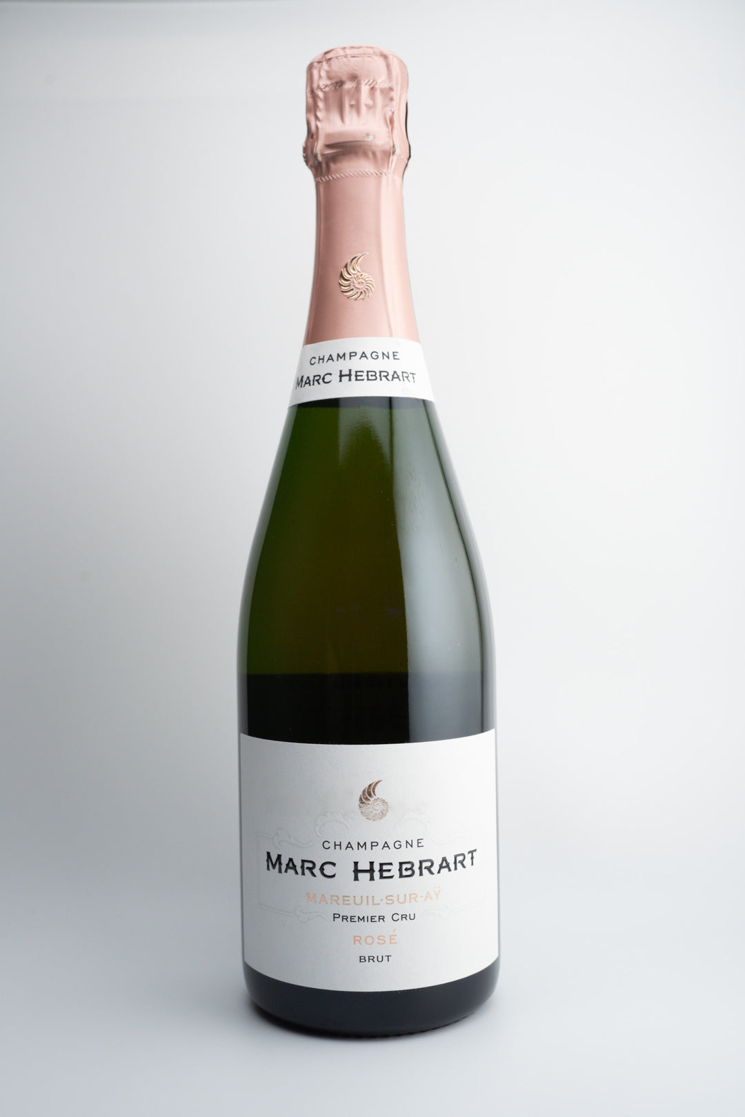 A bottle of Marc Hébrart Premier Cru Brut Rosé Champagne with a pink label and foil cover on top.