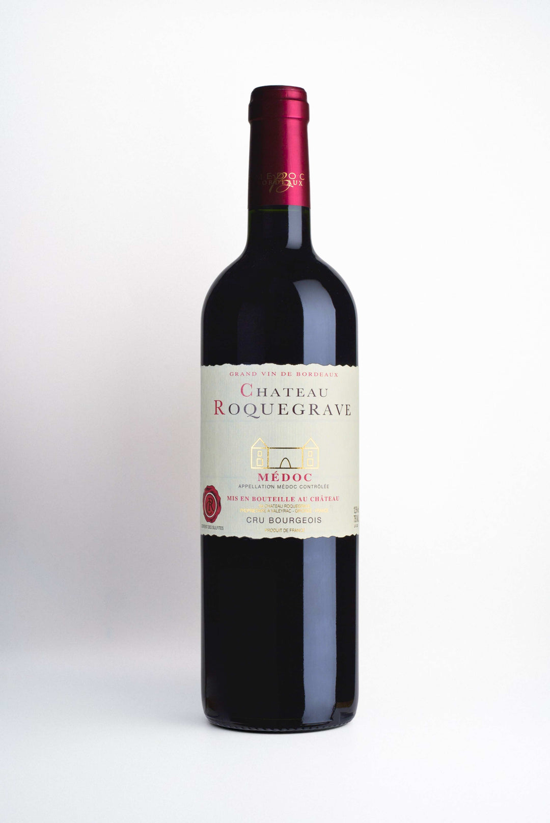 A bottle of Chateau Roquegrave, a Médoc Cru Bourgeois wine from Bordeaux, France, with a red foil cover on a white background.