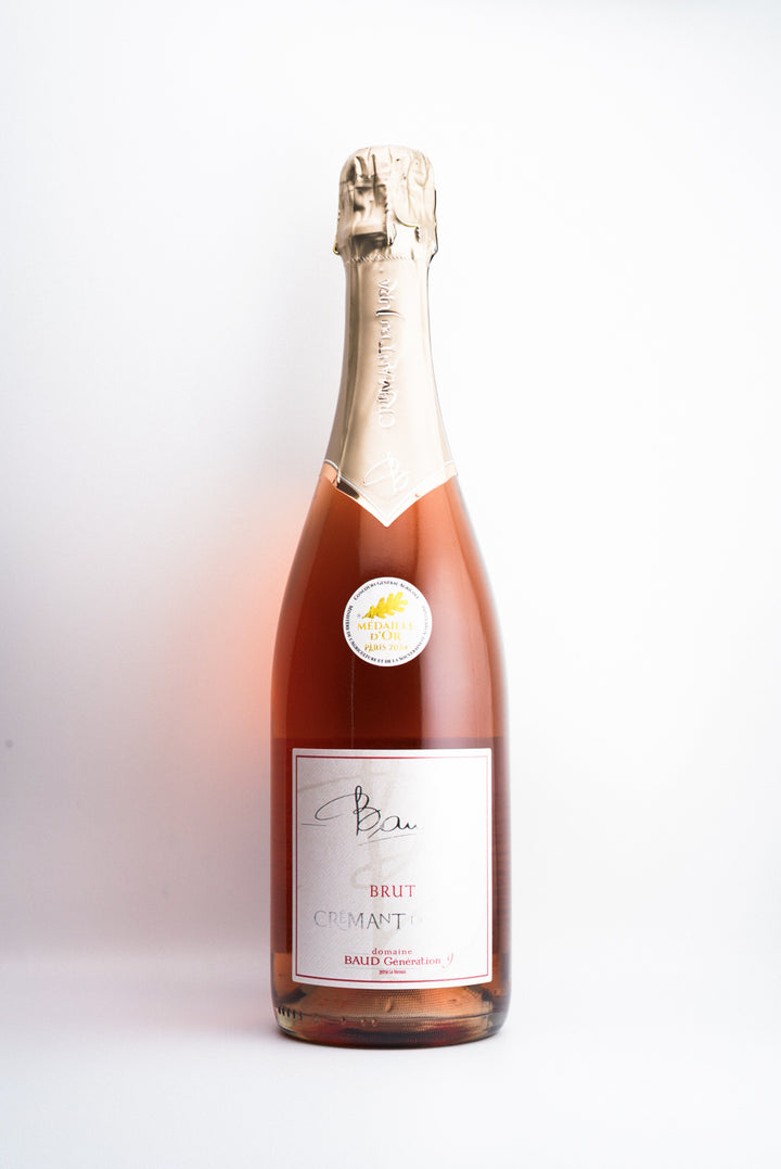 A bottle of Domaine Baud 'Génération 9' Crémant du Jura Brut Rosé sparkling wine from Jura, France.
