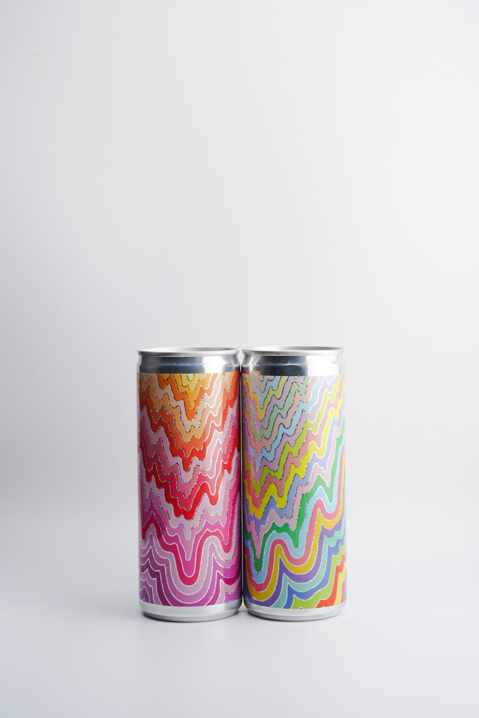 Two cans of wine with colorful, wave-patterned labels.