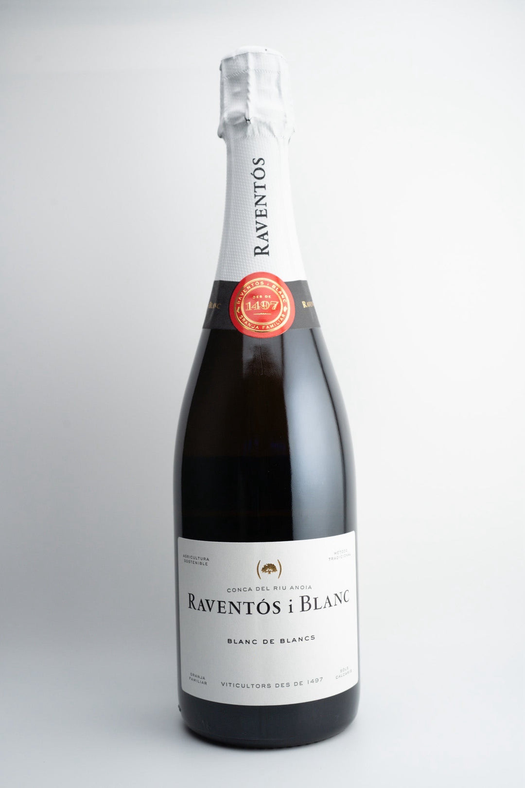 A bottle of Raventós i Blanc 'Blanc de Blancs' Extra Brut sparkling wine with a label and red seal.