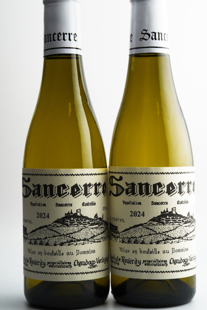 Two bottles of Sancerre wine on a white background