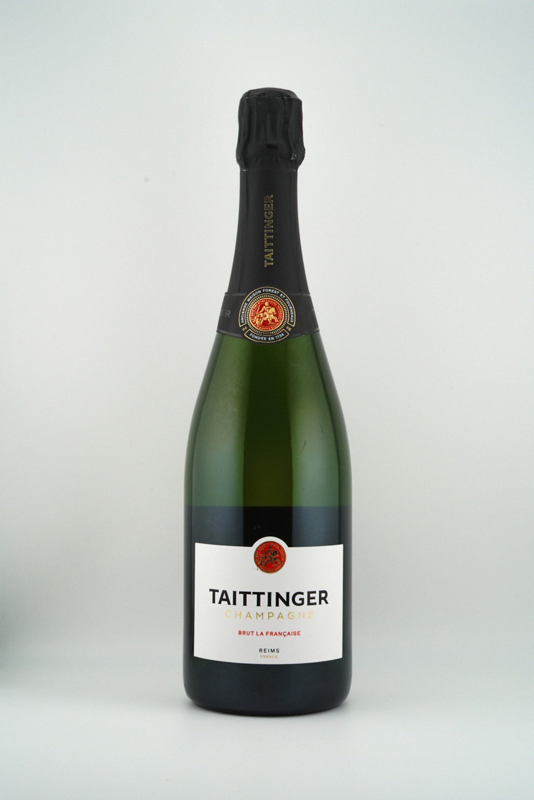 Bottle of Taittinger champagne on a white background